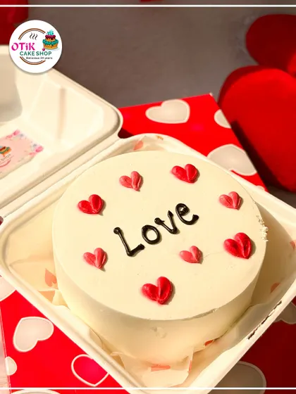 A simple and sweet "Love" bento cake, decorated with tiny red hearts. It's a perfect, understated way to show someone you care on any day of the year.
