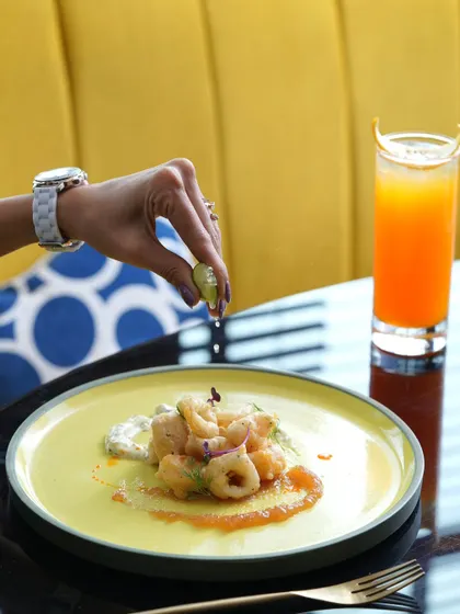 A squeeze of lime over fresh calamari. This dish is part of my four-course tasting menu, offering a satisfying midday escape.