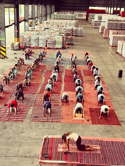 A wide shot of the warehouse turned into a yoga studio. This image captures the scale of the event and the commitment of everyone who participated.