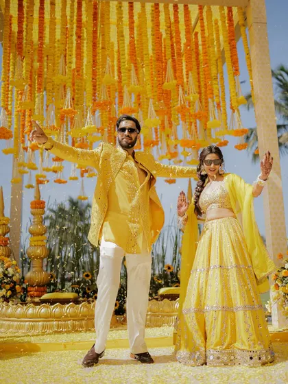 The couple striking a pose before their Haldi ceremony. The vibrant yellow decor and bright sunshine made for a perfect photo.