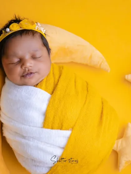 A close-up of the "mango softy" baby, showing the sweet details of the yellow headband and the baby's serene expression.