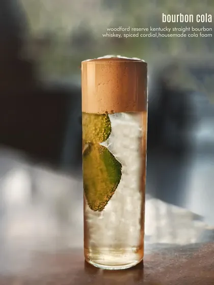 The Bourbon Cola, an elevated take on a classic pairing with house-made cola foam.