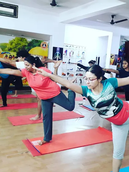 Students practicing Natarajasana (Dancer's Pose), a beautiful and challenging balance pose. This helps improve focus and body awareness.