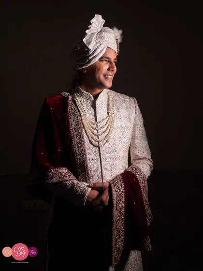 A portrait of the groom, Pratik, looking happy and dashing in his wedding sherwani.