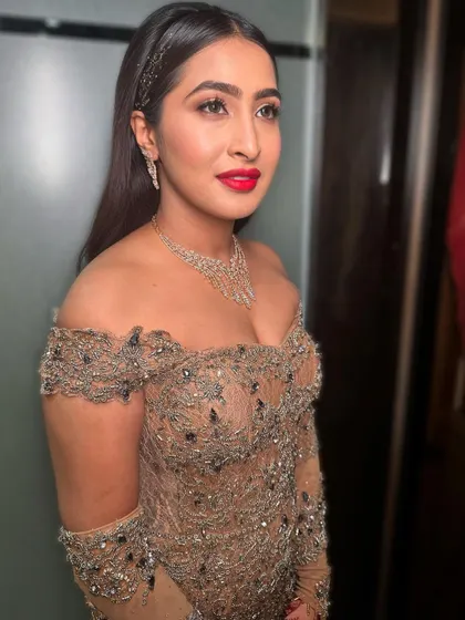 A classic cocktail look featuring a timeless red lip and sleek hair. The makeup is glamorous yet sophisticated.