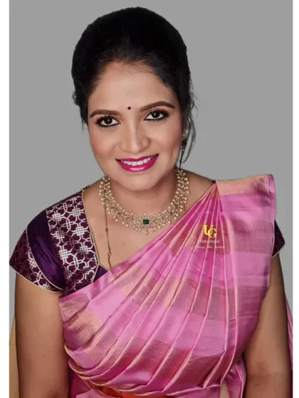A classic portrait of Navya. Her smile shows her happiness with the final look, which is both glamorous and perfectly suited for a traditional family event.