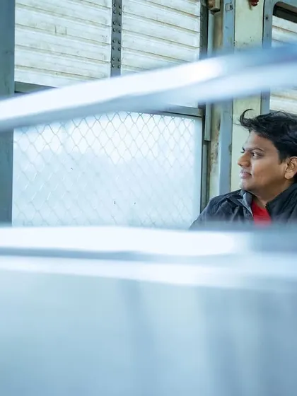 A pre-wedding shoot can happen anywhere that's special to you, even a Mumbai local train. I framed this shot through the window bars to create a sense of a private, stolen moment amidst the public journey.