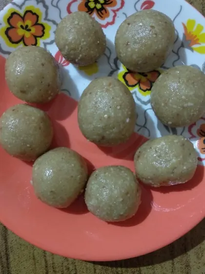A plate of delicious, homemade laddoos ready to be shared. This represents the culmination of a process that involved following instructions, measuring, mixing, and rolling.