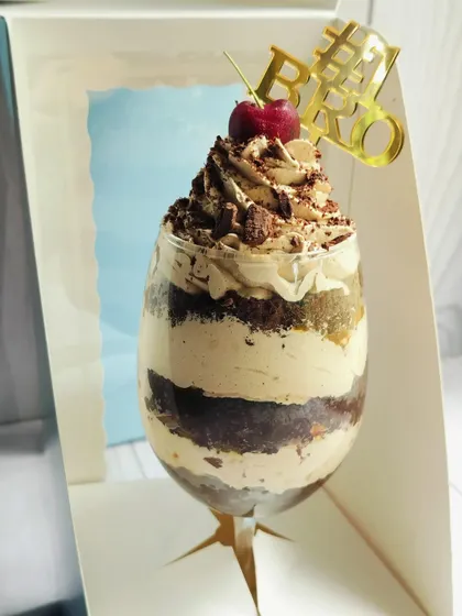 Another angle of the Mocha Mirage Delight, showing the distinct layers of chocolate cake, coffee mousse, and caramel inside the glass.