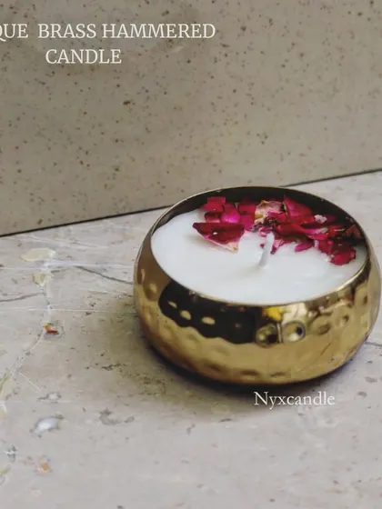 A still shot of our favorite antique brass hammered urli candle, decorated with dried rose petals. A perfect centerpiece for any celebration.