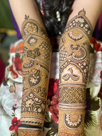 A pair of arms with non-symmetrical but complementary designs, showing creative freedom.