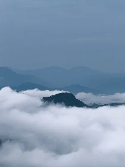A mountain peak rising above a sea of clouds in Mussoorie. This is the kind of view that makes you feel like you're on top of the world.