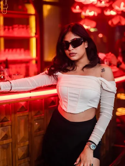 A partygoer posing at the bar at The Fixx.