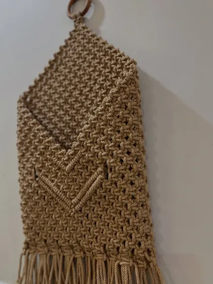 A side view of the pocket wall hanging, showing its depth. It's a functional piece of home decor that helps you stay organized.