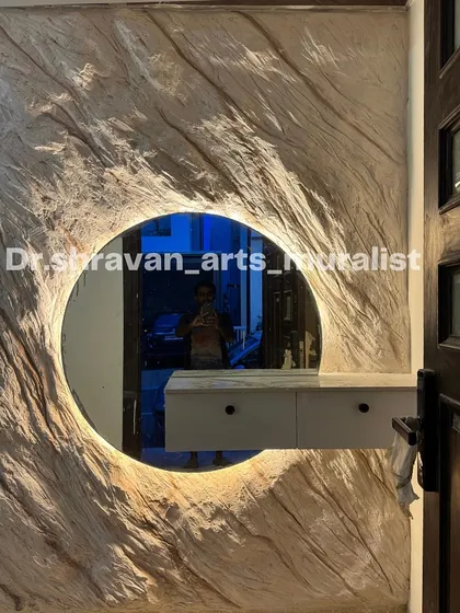 A full view of the rock texture mural with the integrated backlit mirror. It serves as both a vanity area and a piece of sculptural art, setting a sophisticated tone for the home.
