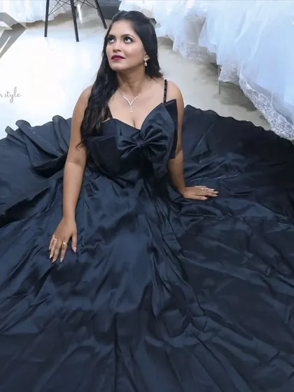 Dare to be dramatic. This black satin ball gown is all about making a bold statement. The voluminous skirt creates a stunning canvas for the oversized architectural bow, a detail I designed for unforgettable impact.