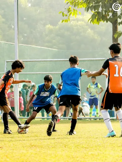 Four players converge on the ball in a tight space.