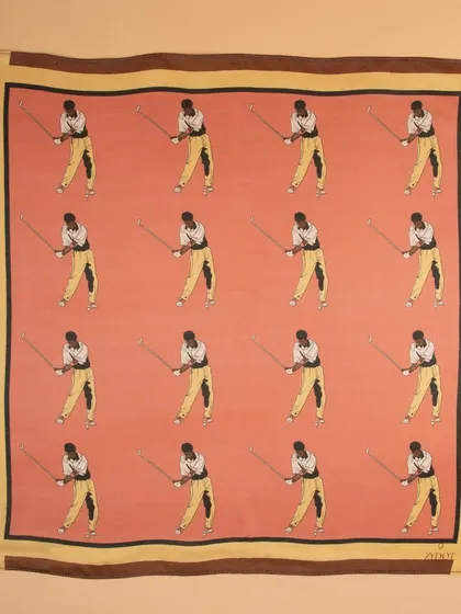 A flat-lay of a pink pocket square with a repeating golfer motif, showing the full pattern and color.