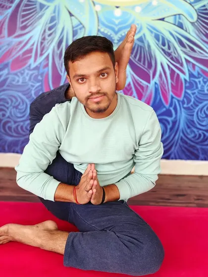 A seated pose with the leg behind the head, Eka Pada Sirsasana, which requires open hips and a flexible spine.