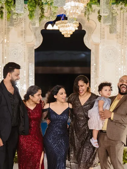 Laughter and joy with friends and family at the reception. The elegant chandelier-lit entryway provides a beautiful backdrop for these priceless candid moments.