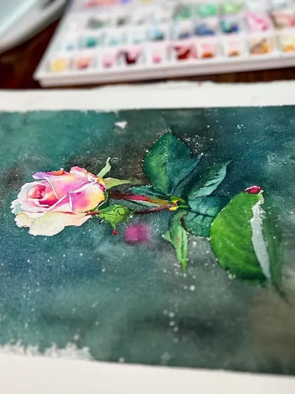 Another angle of the single rose demonstration, showing the texture of the paper and the splatter effect in the background.