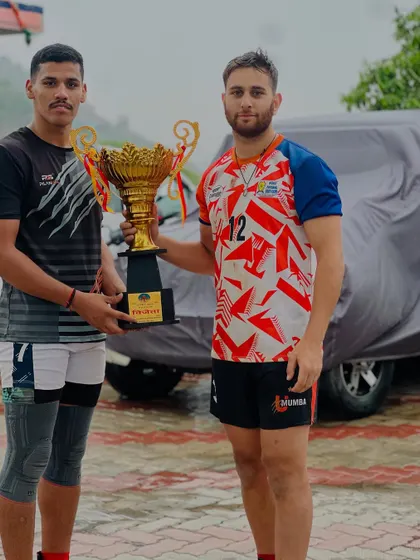 Two of our academy players with the trophy, representing the strength and skill we build.