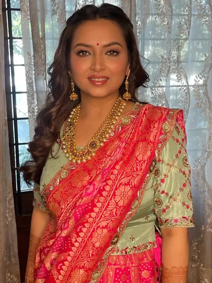 A beautiful portrait showcasing the radiant makeup and traditional gold jewelry.