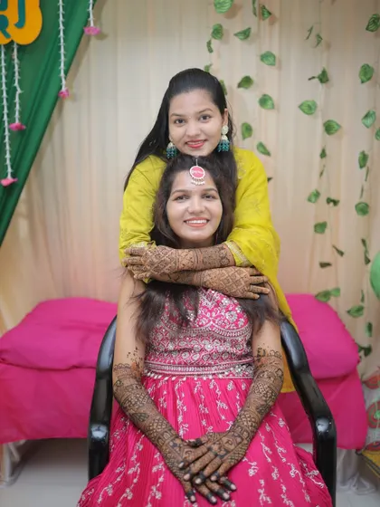 Another lovely photo of the bride with her sister. The bond between them is as beautiful as the henna on their hands.