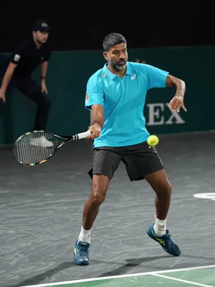Executing a forehand volley during a match. Net play and quick reflexes are vital skills.