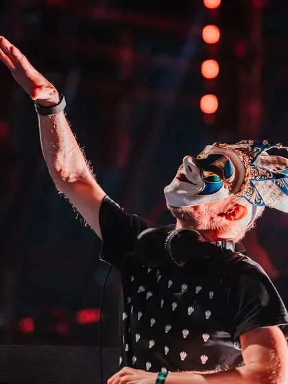 A powerful shot of Boris Brejcha raising his hand to the crowd, a master conductor of the night's energy.
