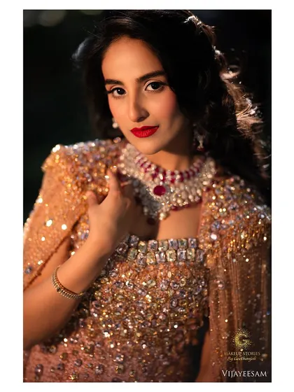 A beautiful sun kissed portrait. The makeup is radiant and glowing, with a bold red lip that looks stunning in the natural light.