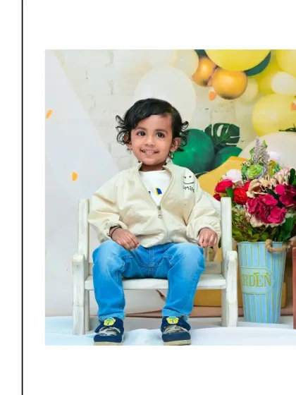 This toddler looks so confident and happy in his casual outfit for his second birthday shoot. These sessions are all about letting their growing personality shine.