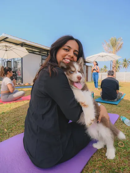 All smiles and puppy cuddles at our Paws & Poses yoga event.
