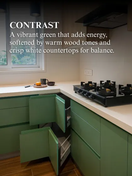 Another view of the sage green kitchen, showing the corner storage solution. The design ensures that every inch of space is utilized effectively, without compromising the clean, modern aesthetic.