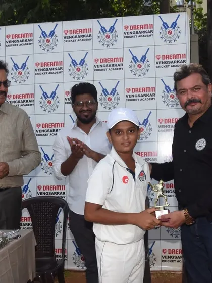 A young cricketer receiving his award at the Dream11 Cup ceremony at Oval Maidan.