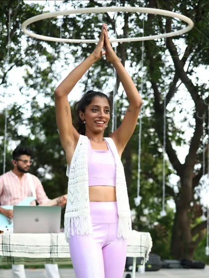 Leading a hula hoop session at Zenfest with live music in the background. The hoop is a halo of happiness, and it's amazing to share that feeling.