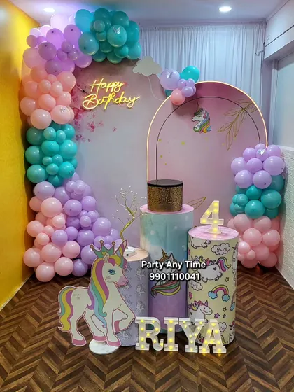 Another take on the unicorn theme, this one for a 4th birthday. It includes a beautiful balloon arrangement in pastel pink, purple, and teal against a custom arch backdrop.