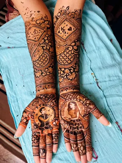 A personalized design featuring couple portraits on the palms and their initials 'K' and 'S' on the forearms. This is a great way to symbolize your union.