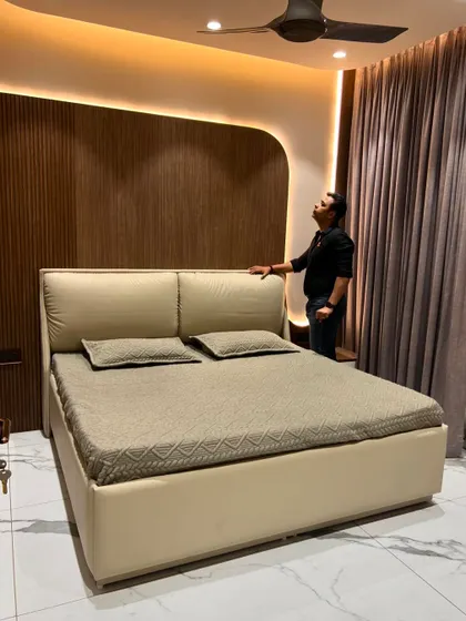Another view of the bedroom, highlighting the warm and inviting atmosphere created by the lighting design.
