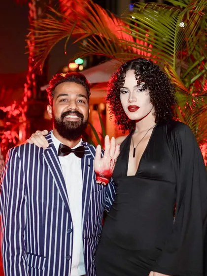 A stylish couple posing at the Halloween party. The striped suit and bloody hand detail were a great touch.