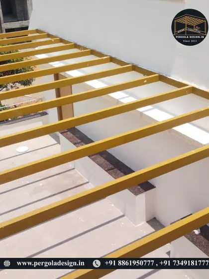 A close-up of the yellow-primed steel frame during the early stages of construction.