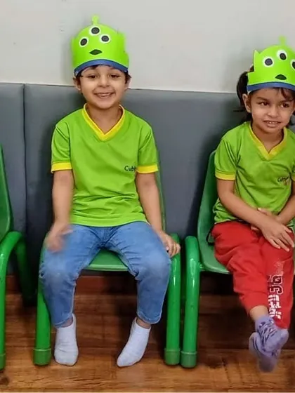 Fun with dress-up. Wearing these cute alien hats, the children are engaging in imaginative play, which is essential for developing creativity and social-emotional skills.