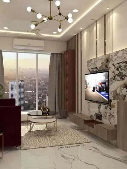 A living room design for a 3BHK in Bhayandar East, featuring a rich color palette with a maroon sofa and a marble-patterned TV wall. The space is designed to feel cozy and luxurious, with large windows providing ample natural light.