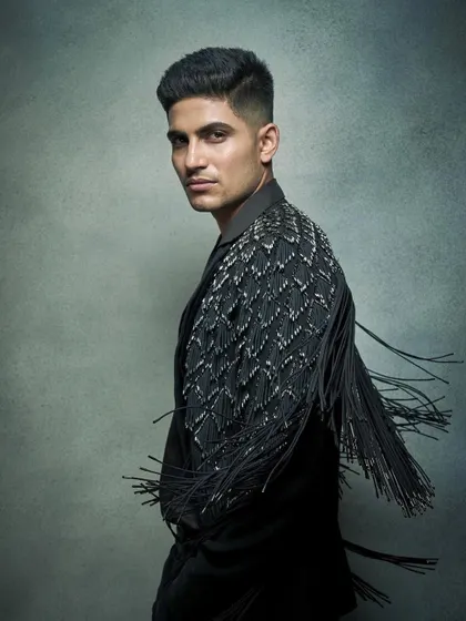 Movement is key in a statement piece. This shot of Shubman Gill in a Rohit Gandhi and Rahul Khanna jacket captures the dramatic swing of the fringe, adding a dynamic edge to his look.