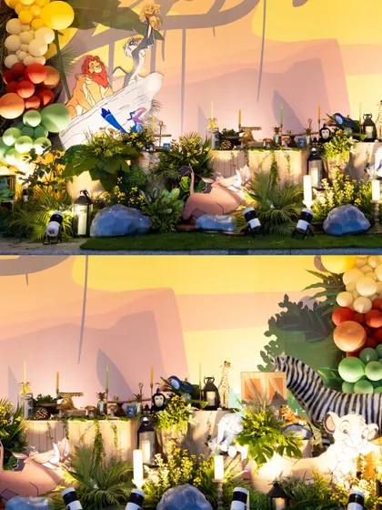 A panoramic view of the elaborate Lion King stage setup, featuring a stunning Pride Rock backdrop, lush greenery, animal props, and dramatic lighting.