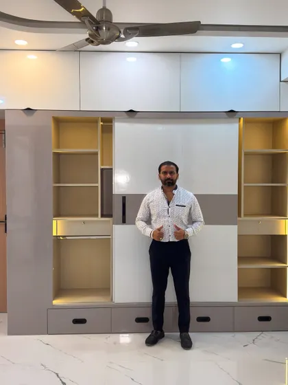 Here I am with a newly installed sliding wardrobe. The dual-tone design with integrated lighting provides ample storage while adding a modern touch to the bedroom.