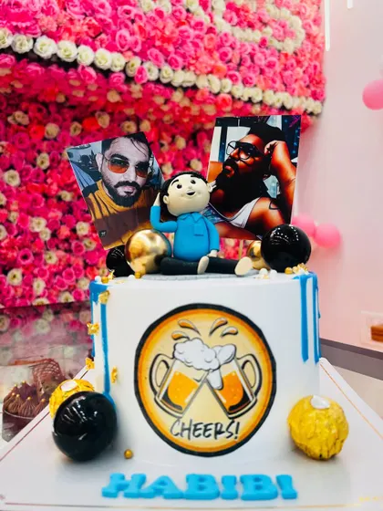A fun, personalized cake with photo prints and a custom caricature. The "Cheers!" beer mug design makes it great for a friend's birthday.