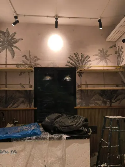 The palm tree mural in the cafe, showing how it works with shelving and other fixtures.