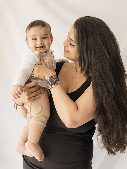 A mother and her happy six-month-old. These milestone sessions are perfect for capturing the playful interactions and beautiful bond that grows every day.