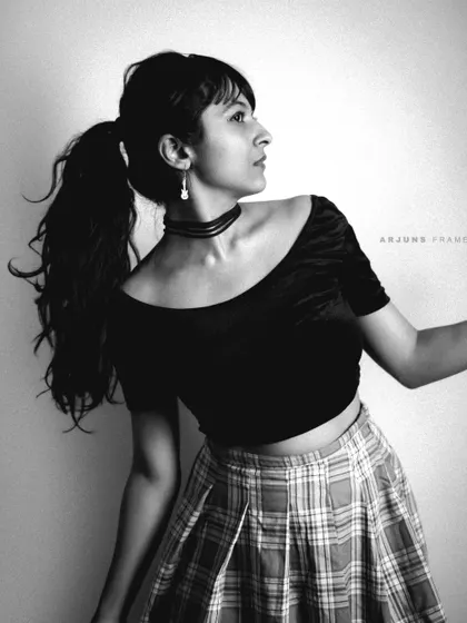A black and white take on the 'Grunge & Glory' theme. This profile shot highlights the off-the-shoulder top and plaid skirt, capturing a vintage, moody aesthetic.
